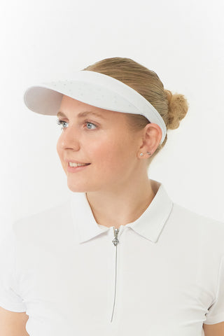 White Clip ladies golf visor,  100% polyester with quick-drying fabrics. The visor comes in a one size fits all design which clips around your head to hold it securely in place. It features a concealed magnet in in the strong curved, crystal detailed peak with a hand enameled flower look golf ball marker attached.  The headband features a soft lined absorbent towel.