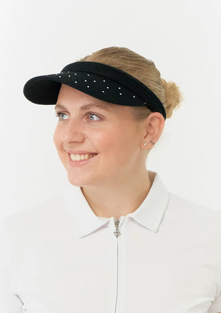 Black Clip ladies golf visor constructed with quick-drying fabrics. The visor comes in a one size fits all design which clips around your head to hold it securely in place. It also features a concealed magnet in peak with a hand enamelled flower look golf ball marker attached.  There is also crystal detailing across the strong curved peak.  The headband features a soft lined absorbent towel. 