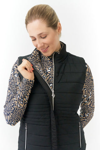 The Pure Golf Eve reversible ladies gilet for golf is insulated, winter-weight, patterned and reversible. It has been Insulated for warmth without being bulky. It has a unique animal print in wild truffle,  on one side and black on the other for versatility of wear. It has pockets on both sides and two-way zippers. The flattering quilting style and fit enhances your silhouette. The colors in this  this piece are Cappuccino,  Champagne and black.  