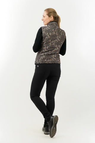 The Pure Golf Eve reversible ladies gilet for golf is insulated, winter-weight, patterned and reversible. It has been Insulated for warmth without being bulky. It has a unique animal print in wild truffle,  on one side and black on the other for versatility of wear. It has pockets on both sides and two-way zippers. The flattering quilting style and fit enhances your silhouette. The colors in this  this piece are Cappuccino,  Champagne and black.  