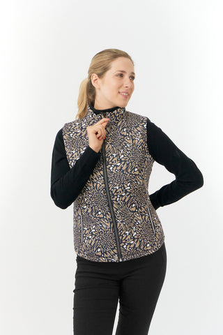 The Pure Golf Eve reversible ladies gilet for golf is insulated, winter-weight, patterned and reversible. It has been Insulated for warmth without being bulky. It has a unique animal print in wild truffle,  on one side and black on the other for versatility of wear. It has pockets on both sides and two-way zippers. The flattering quilting style and fit enhances your silhouette. The colors in this  this piece are Cappuccino,  Champagne and black.  