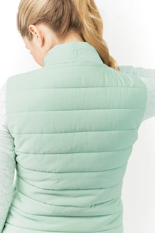 Frosted Sage Pure Golf Eve reversible ladies gilet for golf is insulated, winter-weight, patterned and reversible. It has been Insulated for warmth without being bulky. It has a unique frosted field, floral print  on one side and plain frosted sage on the other for versatility of wear. It has pockets on both sides and two-way zippers. The flattering quilting style and fit enhances your silhouette. 