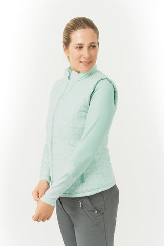 Frosted Sage Pure Golf Eve reversible ladies gilet for golf is insulated, winter-weight, patterned and reversible. It has been Insulated for warmth without being bulky. It has a unique frosted field, floral print  on one side and plain frosted sage on the other for versatility of wear. It has pockets on both sides and two-way zippers. The flattering quilting style and fit enhances your silhouette. 