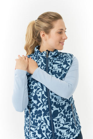 Pure Golf Eve reversible ladies gilet for golf is insulated, winter-weight, patterned and reversible. It has been Insulated for warmth without being bulky. One side features intricate Midnight Rose floral prints in navy and powder blue, while the other offers a classic plain navy option for versatility of wear. It has pockets on both sides and two-way zippers. The flattering quilting style and fit enhances your silhouette. 