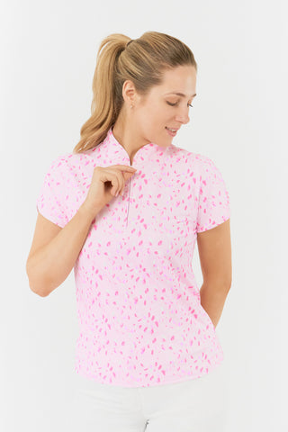 The Pure Golf Rise sleeveless ladies' golf polo shirt in the Soft Sakura design features a delicate print of lilac, pink, and white petals on a soft pink background. With a regular fit and 4-way stretch, it ensures comfort and a flattering shape for all body types. The mandarin collar adds a touch of elegance. Crafted from 95% polyester and 5% spandex, it offers anti-crease, anti-static, and quick-dry properties, along with UPF 50+ sun protection.