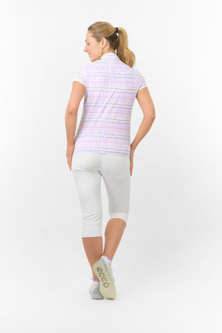 The model shot highlights the back of the Pure Golf Rise Pastel Score Cap Sleeve Ladies' Golf Polo Shirt, featuring soft and refreshing pastel shades that evoke a springtime vibe. With a regular fit and 4-way stretch, it ensures both comfort and a flattering shape for all body types. The mandarin collar adds an elegant touch. Made from 95% polyester and 5% spandex, it offers anti-crease, anti-static, and quick-dry properties, along with UPF 50+ sun protection. Paired with White Trust Capri's. 