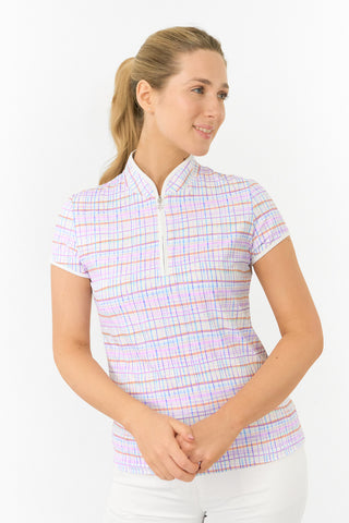 The front model shot showcases the Pure Golf Rise Pastel Score Cap Sleeve Ladies' Golf Polo Shirt, featuring refreshing pastel shades that evoke a springtime vibe. With a regular fit and 4-way stretch, it offers a flattering shape for all body types. The mandarin collar adds an elegant touch. Made from 95% polyester and 5% spandex, it provides anti-crease, anti-static, and quick-dry properties, along with UPF 50+ sun protection. Paired with White Trust Capri's, it completes a stylish, coordinated look.