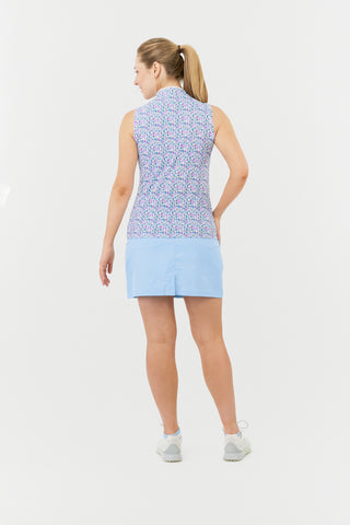 The model image from the back highlights the Pure Golf Rise Over Eighteen Sleeveless Ladies' Golf Polo Shirt, featuring the “Over Eighteen” print with subtle cocktail motifs in a soft blend of blues, lilacs, and pinks. It includes a mid zip with white trim, offering a regular fit and 4-way stretch for comfort across all body types. The mandarin collar adds an elegant touch. Made from 95% polyester and 5% spandex, designed with anti-crease, anti-static, and quick-dry properties, plus UPF 50+ sun protection.