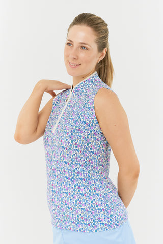 The close up side model shot  highlights the Pure Golf Rise Over Eighteen Sleeveless Ladies' Golf Polo Shirt, featuring the “Over Eighteen” print with subtle cocktail motifs in a soft blend of blues, lilacs, and pinks. It includes a mid zip with white trim, offering a regular fit and 4-way stretch for comfort across all body types. The mandarin collar adds an elegant touch. Made from 95% polyester and 5% spandex, designed with anti-crease, anti-static, and quick-dry properties, plus UPF 50+ sun protection.