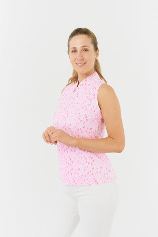 The Pure Golf rise sleeveless ladies' golf polo shirt in Soft Sakura model side shot showcases a subtle print of lilac, pink and white petals on a light pink backdrop. Designed with a regular fit, it offers a 4-way stretch for comfort and a flattering shape on all body types. The mandarin collar offers adds a touch of elegance. Made from 95% Polyester and 5% Spandex, offering anti-crease, anti-static, and quick-dry properties, along with UPF 50+ sun protection. 