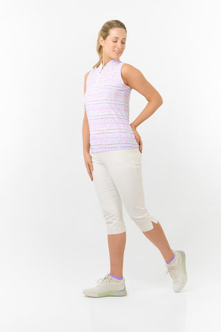 The model shot features the Pure Golf Rise Pastel Score Sleeveless Ladies' Golf Polo Shirt, showcasing soft, refreshing pastel shades that evoke a springtime vibe. Designed with a regular fit and 4-way stretch, it provides comfort and a flattering silhouette for all body types. The mandarin collar adds an elegant touch. Made from 95% polyester and 5% spandex, this polo offers anti-crease, anti-static, and quick-dry properties, along with UPF 50+ sun protection. It is paired with our White Trust Capri's. .