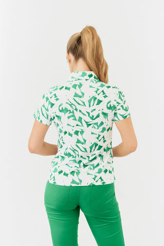 The Pure Golf Amity model shot  showing the back of the short sleeve ladies golf polo shirt with botanical print in emerald green and white. The polo shirt is a regular fit and has a 4 way stretch which ensures it is comfortable and flattering for all body types. It boasts a traditional collar for a classic and stylish look. The polo shirt is anti-crease, anti-static and quick dry with UPF 50+ which is 95% Polyester and 5% Spandex. 