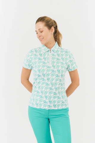 The front model shot of the Pure Golf Amity Short Sleeve Ladies' Golf Polo Shirt in Floating Palms White, featuring a striking all-over botanical print in Ocean Colour against a crisp white background. This regular-fit polo offers a 4-way stretch for comfort and a flattering fit on all body types. The traditional collar adds a classic touch. Designed to be anti-crease, anti-static, and quick-drying, the shirt also offers UPF 50+ sun protection, made from 95% Polyester and 5% Spandex.