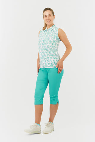 The Pure Golf side model shot features the Amity Short Sleeve Ladies' Golf Polo Shirt in Floating Palms White, showcasing a striking all-over botanical print in Ocean Colour on a crisp white background. This regular-fit polo offers a 4-way stretch for comfort and a flattering fit for all body types. With its traditional collar, it exudes a classic look. Designed to be anti-crease, anti-static, and quick-drying, the shirt also provides UPF 50+ sun protection, crafted from 95% Polyester and 5% Spandex.