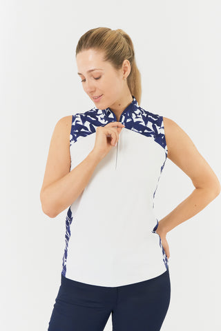 The Pure Golf Freda model front shot showcases the sleeveless ladies' golf polo shirt, featuring a botanical print in Navy and white over the shoulder, sides and mandarin collar with a white body. The regular-fit polo shirt has a 4-way stretch for comfort and a flattering fit on all body types. The shirt is designed to be anti-crease, anti-static, and quick-drying, with UPF 50+ protection. Made from 95% Polyester and 5% Spandex. 