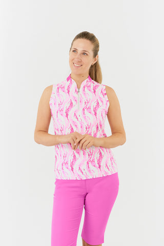 The Pure Golf Felicity model shot showcases the sleeveless ladies' golf polo shirt, featuring layers of soft feathers in a subtle pink shade. Regular fit and 4-way stretch, it ensures comfort and a flattering fit for all body types. The polo shirt is designed with a sweetheart collar for an elegant touch. It is anti-crease, anti-static, and quick-drying, offering UPF 50+ sun protection. Made from 95% Polyester and 5% Spandex, it is paired with Azalea Pink Bermuda Shorts.