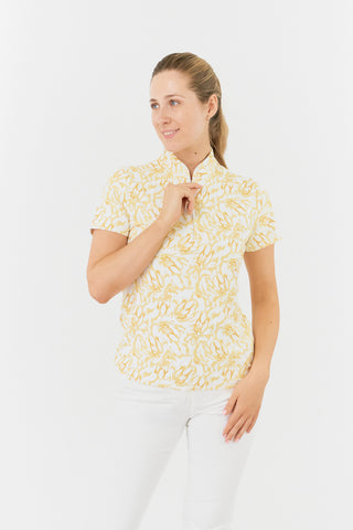 
The Pure Golf Ellen short-sleeve ladies' polo shirt is shown in a front view, highlighting the sunkissed print and warm honey hues. It is paired with white Bermuda shorts. Designed with a regular fit, the polo offers a 4-way stretch for comfort and a flattering shape on all body types. The trendy sweetheart collar adds a fashionable detail. Made from 95% polyester and 5% spandex, this polo features anti-crease, anti-static, and quick-dry properties, as well as UPF 50+ sun protection.