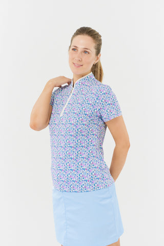 The Pure Golf Ellen short-sleeve ladies' polo shirt model shot slight side view showcasing our Over Eighteen Print featuring cocktail motifs in a subtle scale. Designed with a regular fit, it offers a 4-way stretch for comfort and a flattering shape on all body types. The stylish sweetheart collar adds a fashionable touch. This polo is made from 95% Polyester and 5% Spandex, offering anti-crease, anti-static, and quick-dry properties, along with UPF 50+ sun protection.