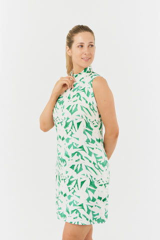 The Pure Golf model shot of the Wild Peony Emerald Miley Sleeveless dress highlights our botanical print. Crafted from 4-way stretch fabric for improved flexibility and unrestricted movement, it ensures a flattering fit for all body types and includes detachable shorts for added versatility and coverage. The mock neck collar adds a sleek, modern touch. Designed to be anti-crease, anti-static, and quick-drying, this dress offers UPF 50+ protection. It is made from 95% Polyester and 5% Spandex.