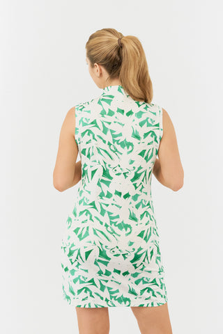 The Pure Golf from the back model shot of the Wild Peony Emerald Miley Sleeveless dress highlights our botanical print. Crafted from 4-way stretch fabric for improved flexibility and unrestricted movement, it ensures a flattering fit for all body types and includes detachable shorts for added versatility and coverage. The mock neck collar adds a sleek, modern touch. Designed to be anti-crease, anti-static, and quick-drying, this dress offers UPF 50+ protection. It is made from 95% Polyester and 5% Spandex.