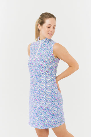 Pure Golf side view model shot of the Miley Sleeveless dress features our “Over Eighteen” print of cocktail motifs in a subtle scale and a mixture of blues and pinks. Made in 4-way stretch material for maximum flexibility and unrestricted movement with detachable shorts for coverage. The mock neck collar offers a sleek, modern look and is a flattering fit on all body types. Designed to be anti-crease, anti-static, and quick drying. It provides UPF 50+, 95% Polyester and 5% Spandex.