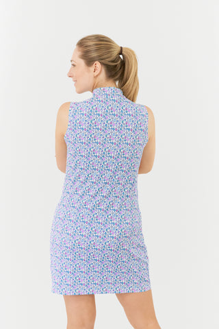 The Pure Golf model shot of the Miley Sleeveless Dress from the back showcases our "Over Eighteen" print, featuring cocktail motifs in a subtle scale, with a blend of blues and pinks from the back. Made from 4-way stretch fabric, it ensures maximum flexibility, a flattering fit for all body types and detachable shorts for added coverage. The mock neck collar provides a sleek look. Anti-crease, anti-static, and quick-drying, this dress also offers UPF 50+ protection. Made from 95% Polyester and 5% spandex. 