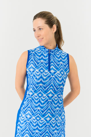 The Pure Golf model shot highlights the top of the Sophie Sleeveless dress, in our Santorini Skies print in shades of blue and white, complemented by a flattering Royal Blue side panel. Crafted from 4-way stretch fabric, it offers freedom of movement, with detachable shorts for added coverage. The mock neck collar adds a sleek touch, and the dress is designed to flatter all body types. Built to resist creasing, static, and moisture, providing UPF 50+ protection. Made from 95% Polyester and 5% Spandex. 