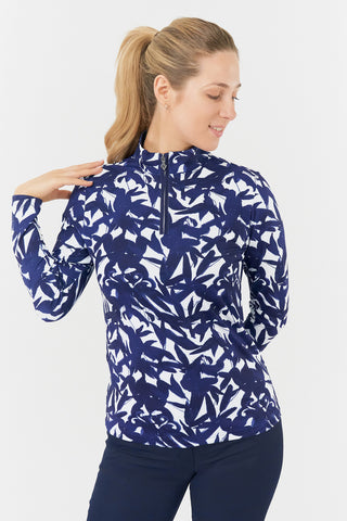 The front view of the Pure Golf Serenity long-sleeve ladies' golf zip top features our botanical print in Wild Peony Navy. Designed with a regular fit, it provides a 4-way stretch for comfort and a flattering shape on all body types. The mock neck collar adds a sleek, modern look while offering extra coverage. Made from 95% Polyester and 5% Spandex, the fabric offers anti-crease, anti-static, and quick-dry properties, as well as UPF 50+ sun protection. 