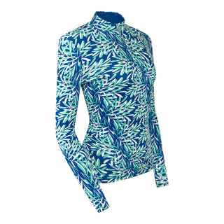 The Pure Golf Serenity long-sleeve ladies' golf zip top product shot showcases a soothing aquatic design in multi-blue and ocean tones, featuring a floating palms print. Designed with a regular fit, it offers 4-way stretch for comfort and a flattering shape on all body types. The mock neck collar adds a sleek, touch. Made from 95% Polyester and 5% Spandex, the top has anti-crease, anti-static, and quick-dry properties, along with UPF 50+ sun protection. A must have for the course.