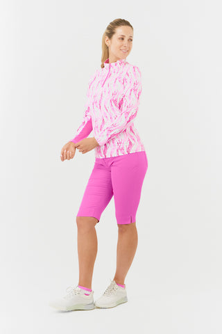 The Pure Golf Balance long-sleeve ladies' golf zip top in Rose Water, featured in a side product shot, showcases layers of delicate petals in shades of pink. Designed with a regular fit, it offers 4-way stretch for ultimate comfort and flexibility on all body types. The mock neck collar adds a sleek touch, while the mesh sleeve panels improve breathability. Made from 95% Polyester and 5% Spandex, the top is anti-crease, anti-static, quick-drying, and provides UPF 50+ sun protection.