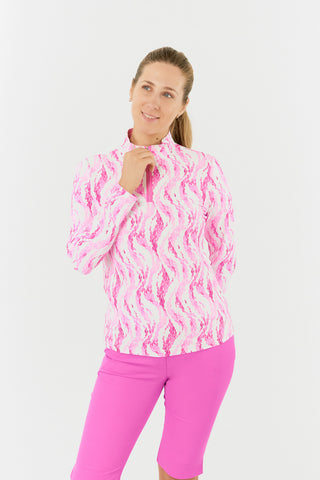 The Pure Golf Balance long-sleeve ladies' golf zip top in Rose Water, shown in a front model shot, features layers of delicate petals in shades of pink. Designed with a regular fit, it provides 4-way stretch for flexibility across all body types. The mock neck collar adds a modern touch, while the mesh sleeve panels enhance breathability. Made from 95% Polyester and 5% Spandex, the top is anti-crease, anti-static, quick-drying, and offers UPF 50+ sun protection. It pairs with Azalea Pink Bermuda Shorts.