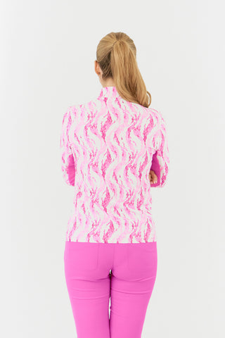 The Pure Golf Balance long-sleeve ladies' golf zip top in Rose Water, shown in a back model shot, features layers of delicate petals in varying shades of pink. With a regular fit, it offers 4-way stretch for comfort across all body types. The mock neck collar adds a sleek, modern touch, while the mesh sleeve panels enhance breathability. Made from 95% Polyester and 5% Spandex, the top is anti-crease, anti-static, quick-drying, and provides UPF 50+ sun protection. Paired with Azalea Pink Bermuda Shorts. 