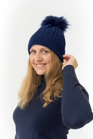 Navy ladies golf hat In an attractive cable knit design. This hat has three layers - an inner waterproof layer plus a soft fleece lining which makes it warm and comfortable. Detachable natural look faux fur bobble.