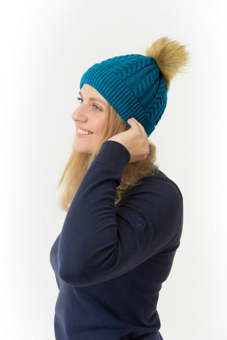 Teal ladies golf hat In an attractive cable knit design. This hat has three layers - an inner waterproof layer plus a soft fleece lining which makes it warm and comfortable. Detachable faux fur bobble in natural colours.